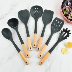 Silicone kitchenware set with wooden handles. Kitchen tools: silicone spatula, strainer, frying spatula